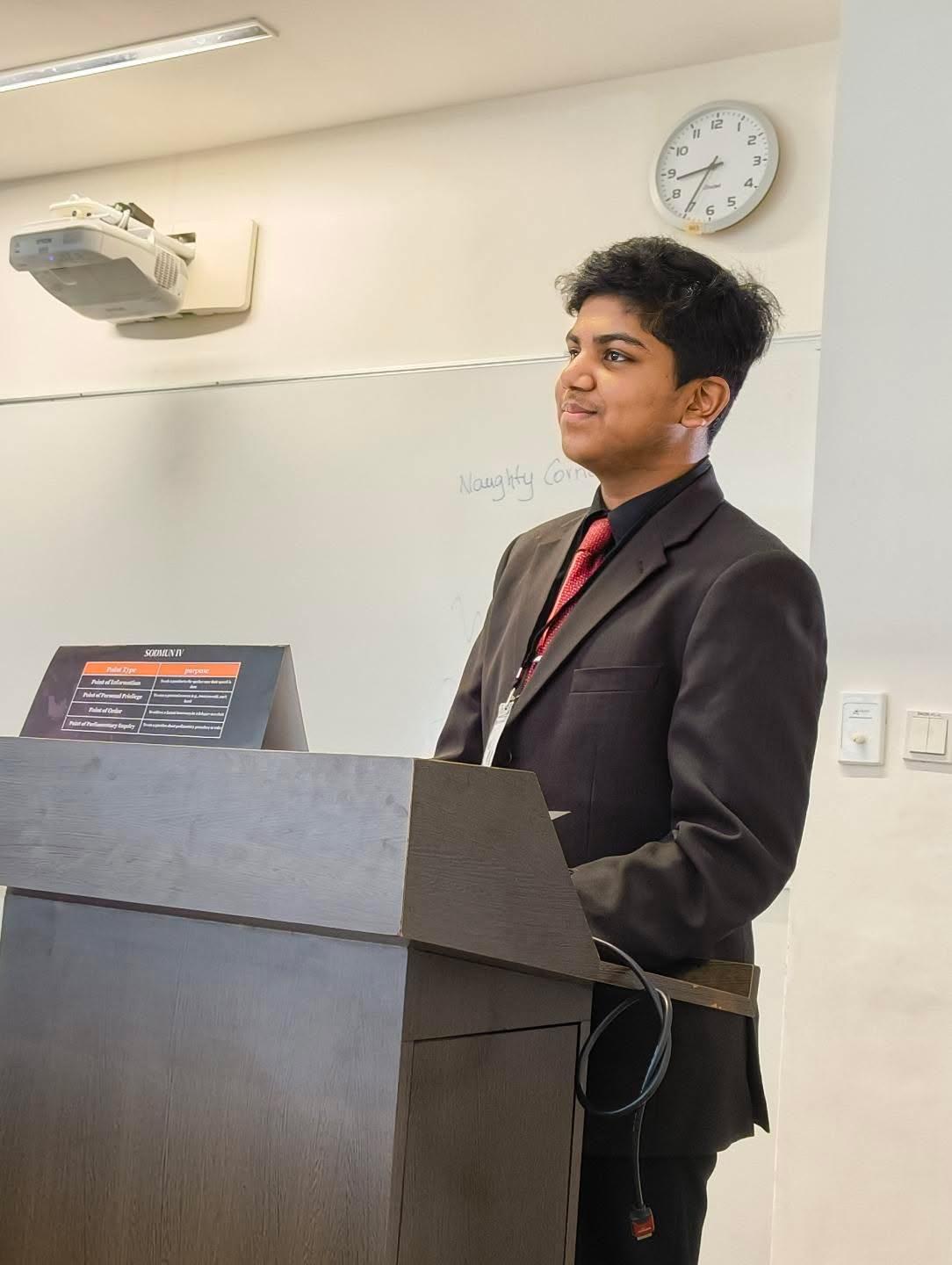 Nirbav Sankar delivering a speech at the SODMUN IV podium